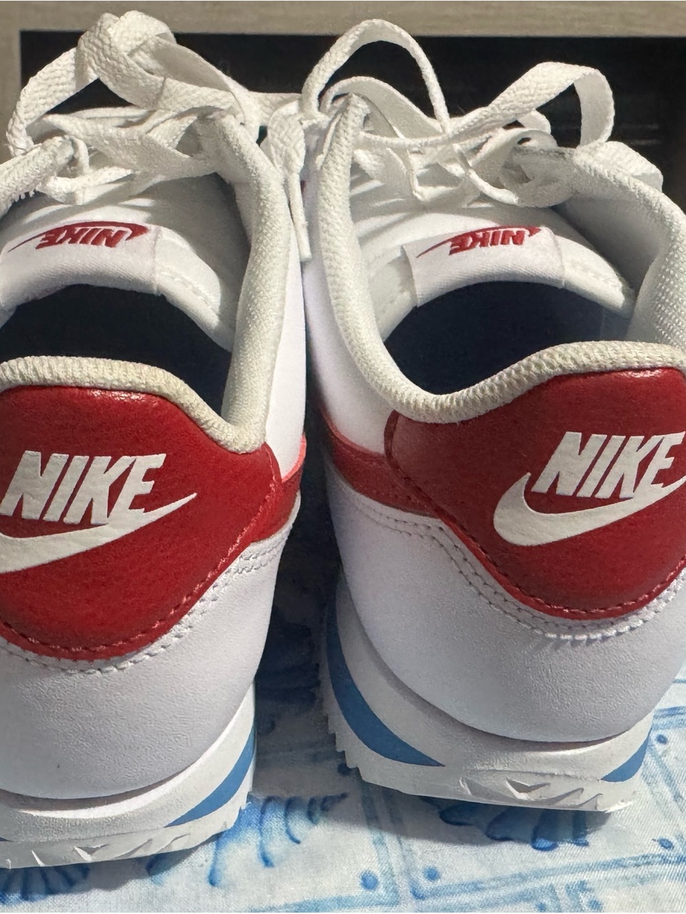 Nike White Sneakers with Red Heel and Blue Midsole Accents